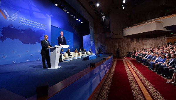 Президент России Владимир Путин (слева) выступает на пленарном заседании межрегионального форума Общероссийского народного фронта (ОНФ) в Ставрополе