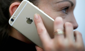 A woman holds an iPhone