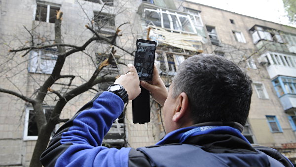 Сотрудник миссии ОБСЕ осматривает дом в Донецке. Архивное фото