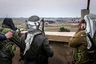 Fighters of the Kurdish People's Protection Units (YPG) carry their weapons and use a pair of binoculars in the outskirts of Tal Tamr town as they monitor the movements of Islamic State fighters who recently captured several villages February 25, 2015. Kurdish militia pressed an offensive against Islamic State in northeast Syria on Wednesday, cutting one of its supply lines from Iraq, as fears mounted for dozens of Christians abducted by the hardline group. The Assyrian Christians were taken from villages near the town of Tel Tamr, some 20 km (12 miles) to the northwest of the city of Hasaka. There has been no word on their fate. There have been conflicting reports on where the Christians had been taken. REUTERS/Rodi Said