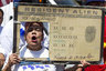 Los Angeles, California, U.S - A woman with a ''Green Card'' sign, shouts slogans as thousands of people participate in the May Day march. In celebration of May Day, people have gathered across the country to rally for various topics including immigration reform.