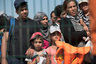 Syrian migrants who were rescued by Turkish Coast Guard while trying to cross in boats to Greece, walk towards a bus to be taken to the nearby city of Izmir to be processed by immigration officials, in Cesme, Turkey, Wednesday, Aug. 12, 2015. Turkish Coast Guard officers in Cesme say they've rescued 111 migrants as they attempted to reach the nearby Greek island of Chios. (AP Photo/Sait Serkan Gurbuz)